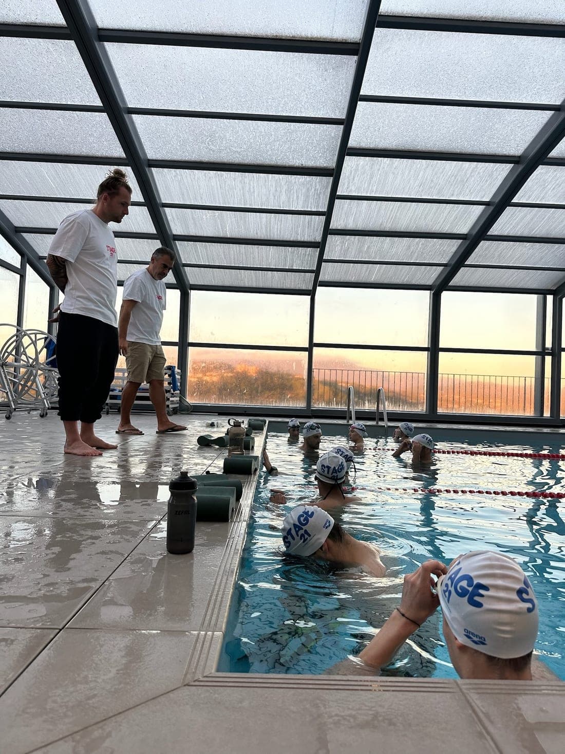 Pool session at sunset, Stage 21 coaches and swimmers