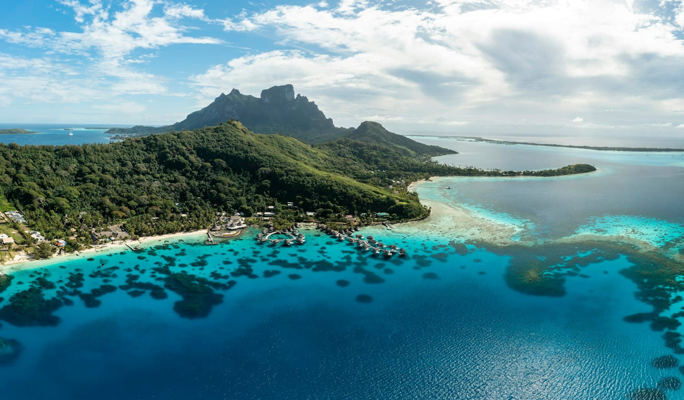 Volcanic peak and turquoise lagoon of French Polynesia seen from above