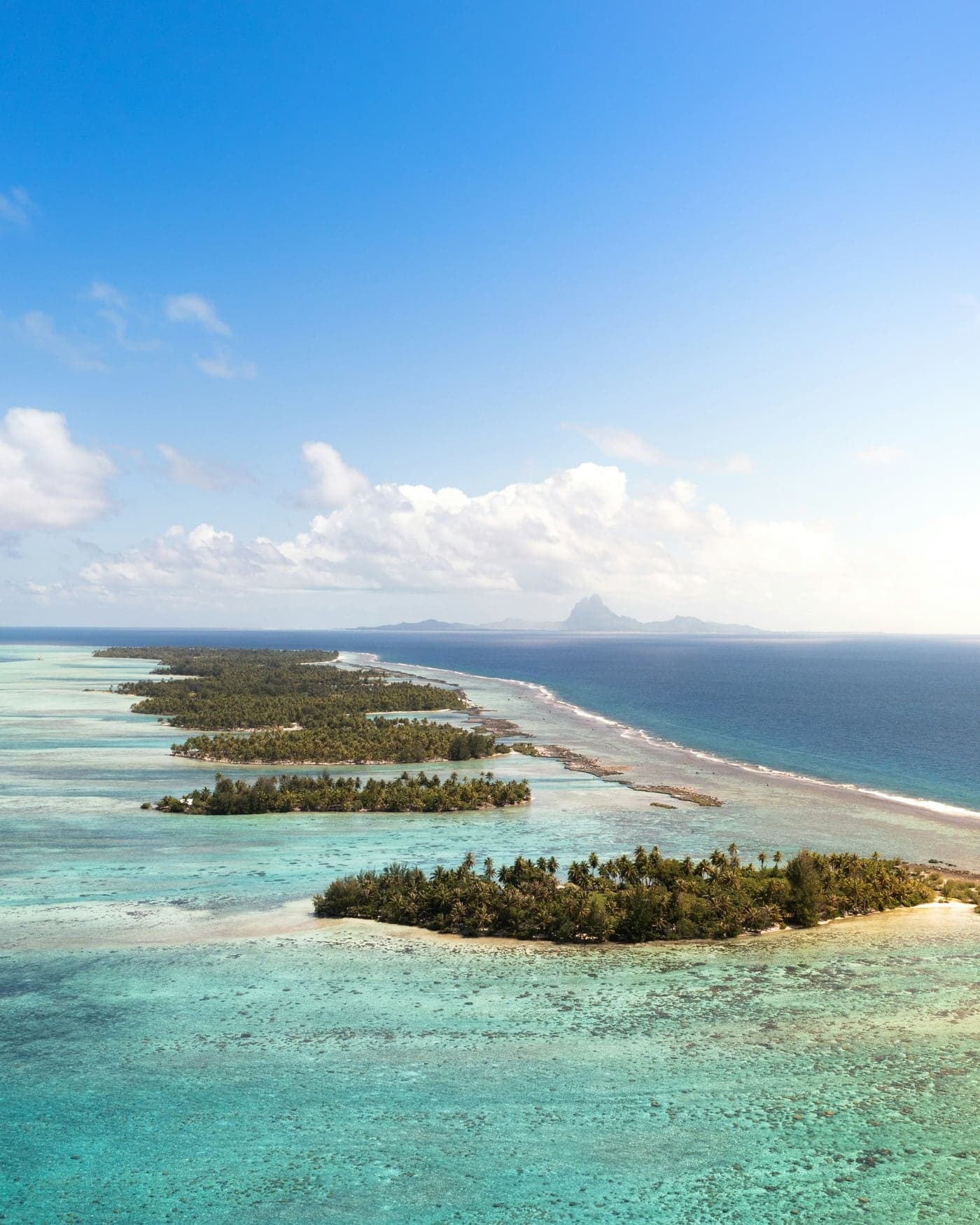Turquoise lagoon and motu of French Polynesia, aerial view
